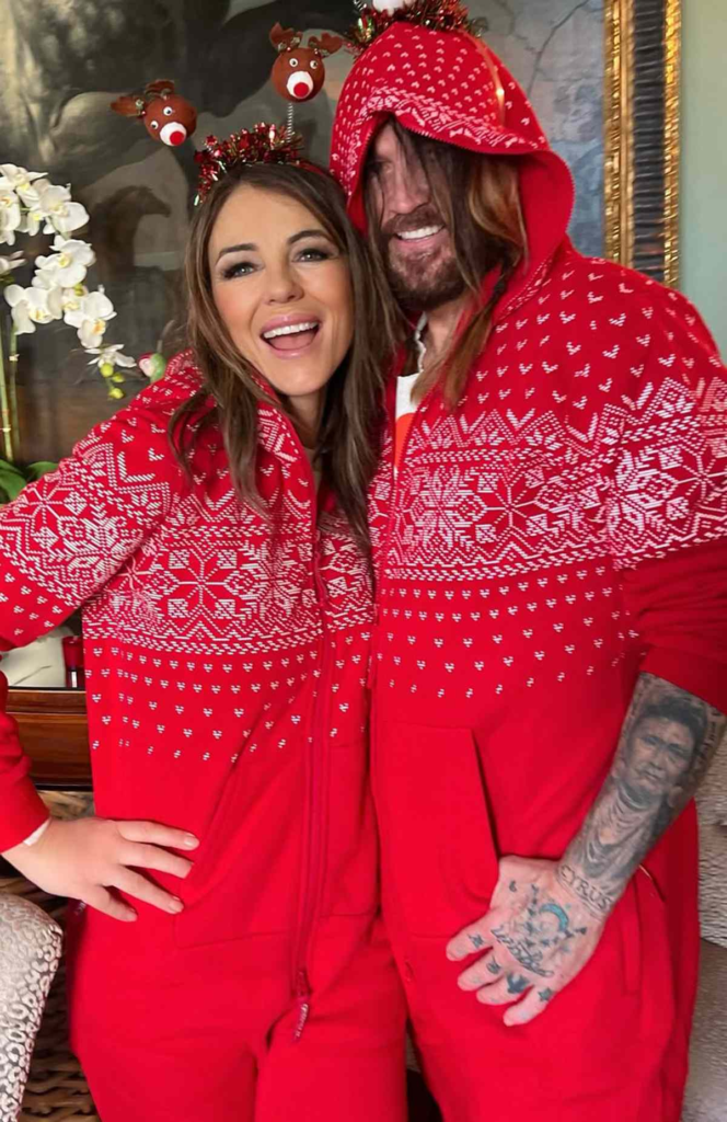 Billy Ray Cyrus and Elizabeth Hurley wearing matching Christmas PJs