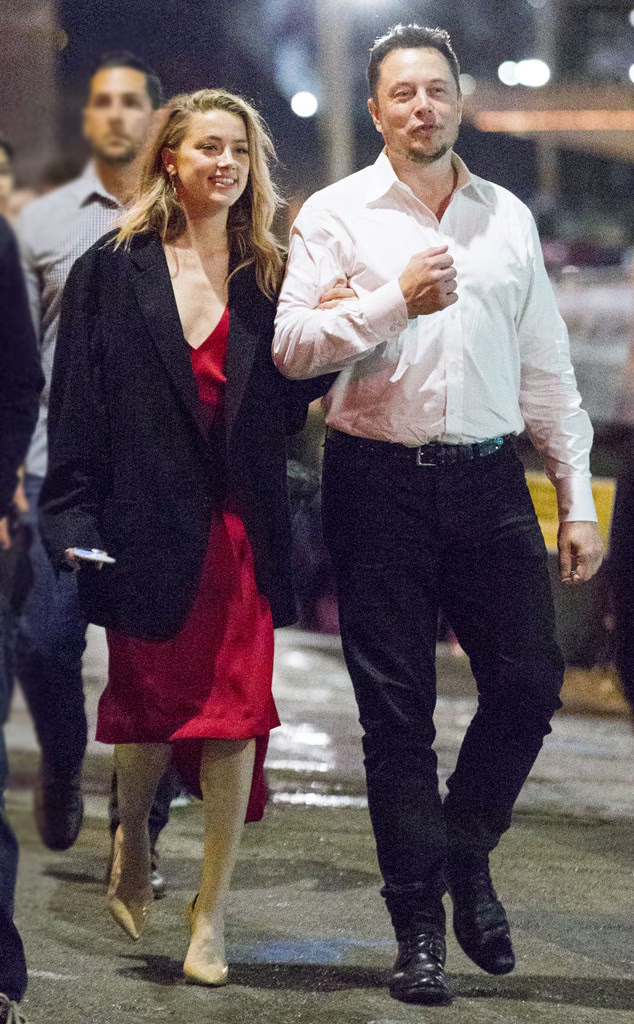 Amber Heard and Elon Musk holding hands