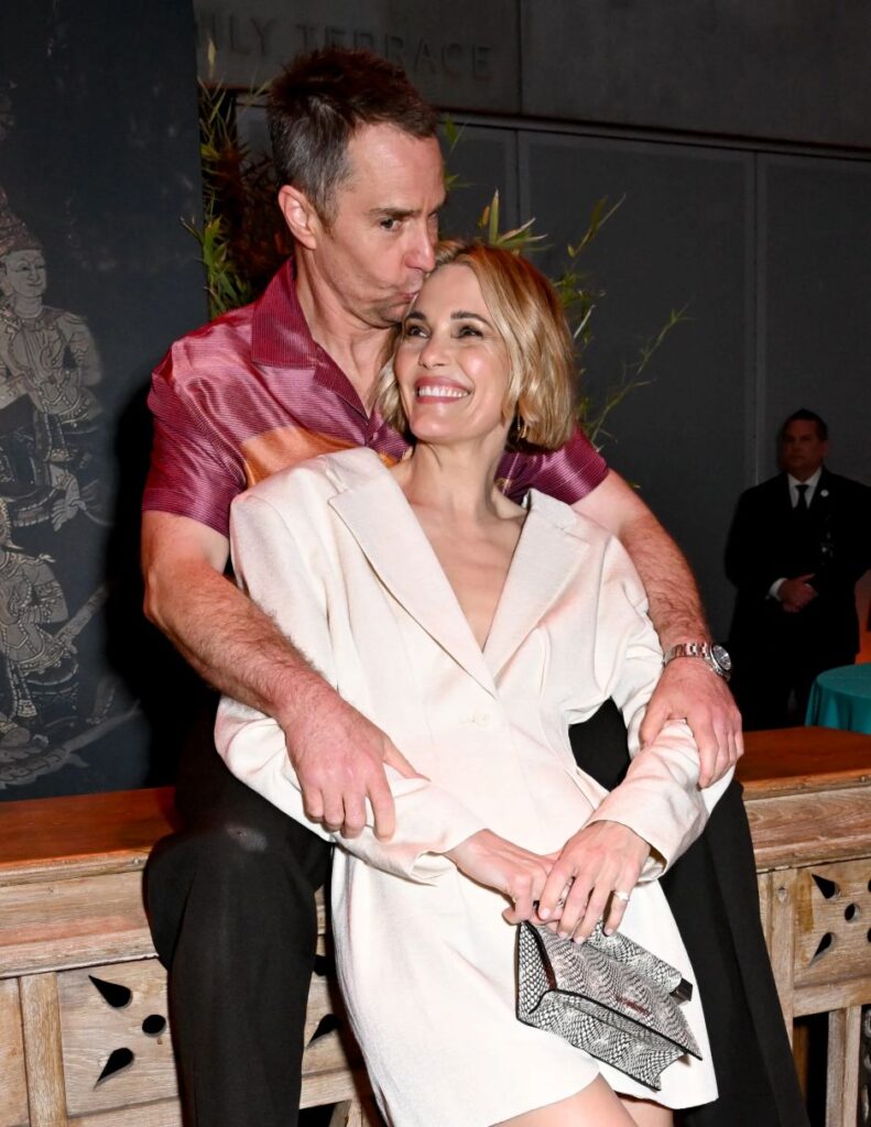 Sam Rockwell and Leslie Bibb holding themselves