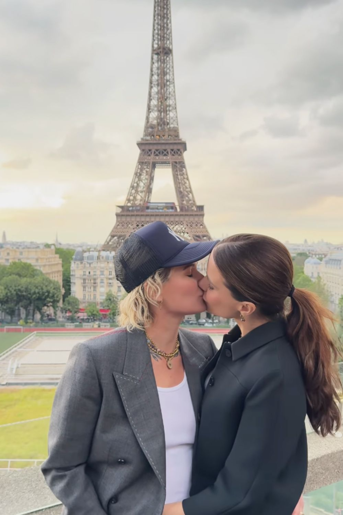 Sophia Bush and Ashlyn Harris kissing by the Eiffel Tower