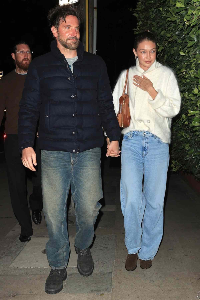 Bradley Cooper and Gigi Hadid holding hands while walking