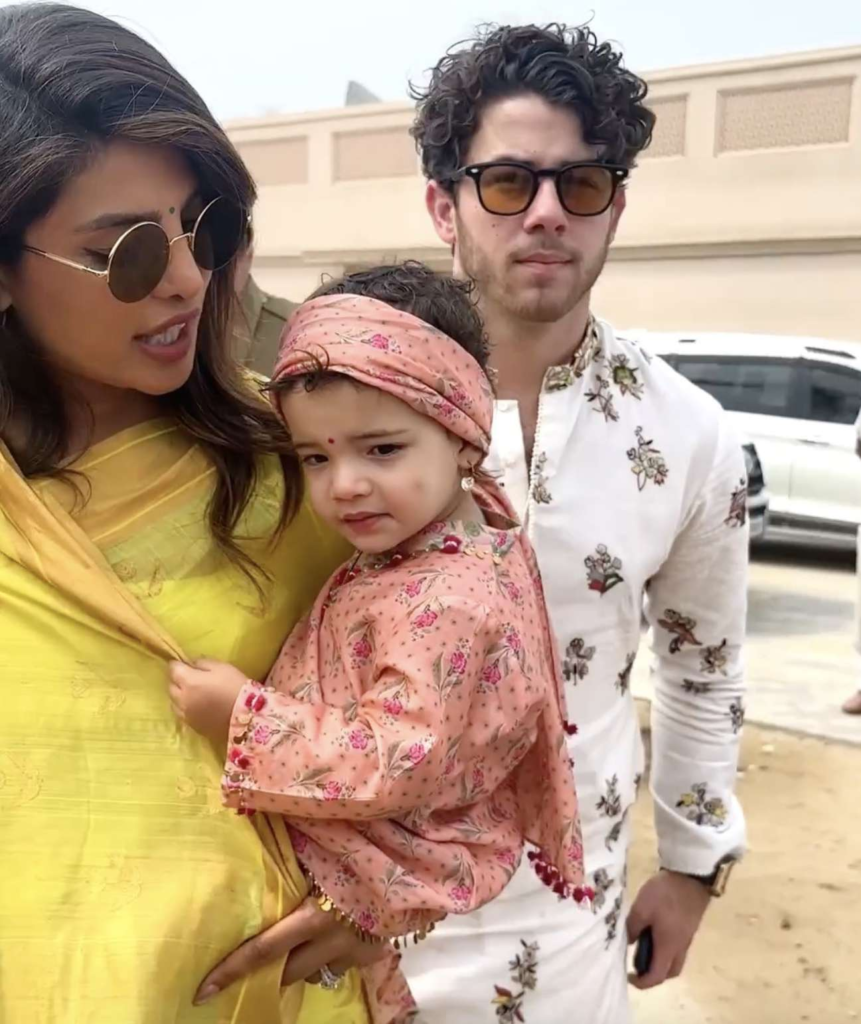 Nick Jonas and Priyanka Chopra with their daughter