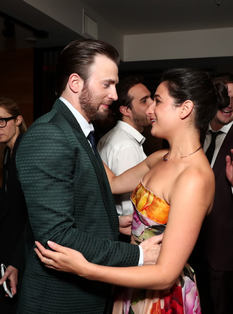 Chris Evans and Jenny Slate hugging at an event