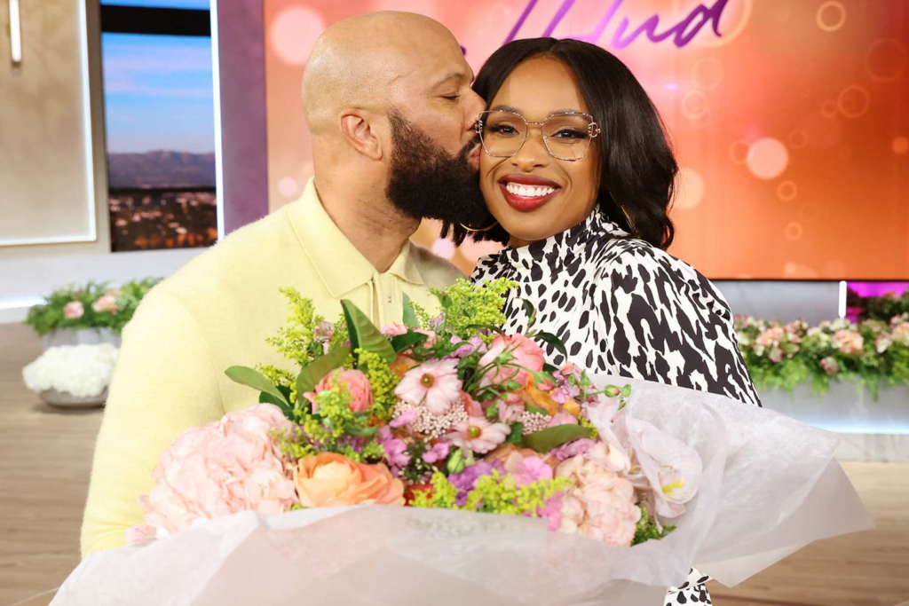 Jennifer Hudson and Common holding a flower bouquet