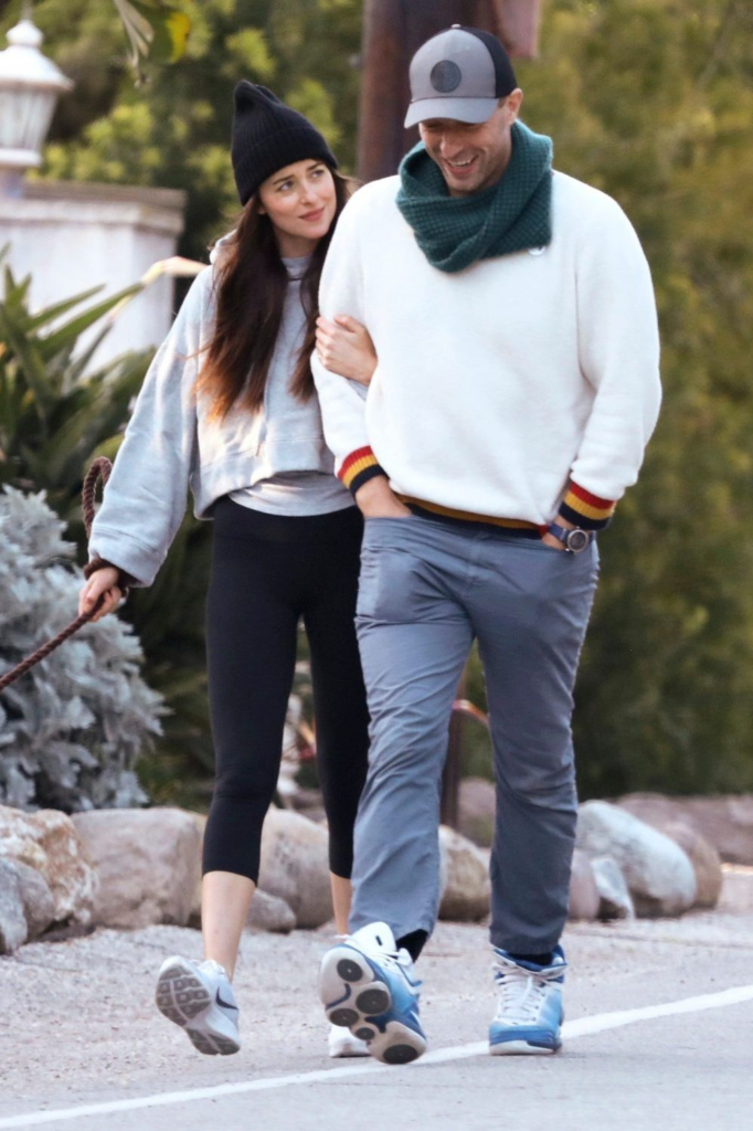 Chris Martin and Dakota Johnson walking