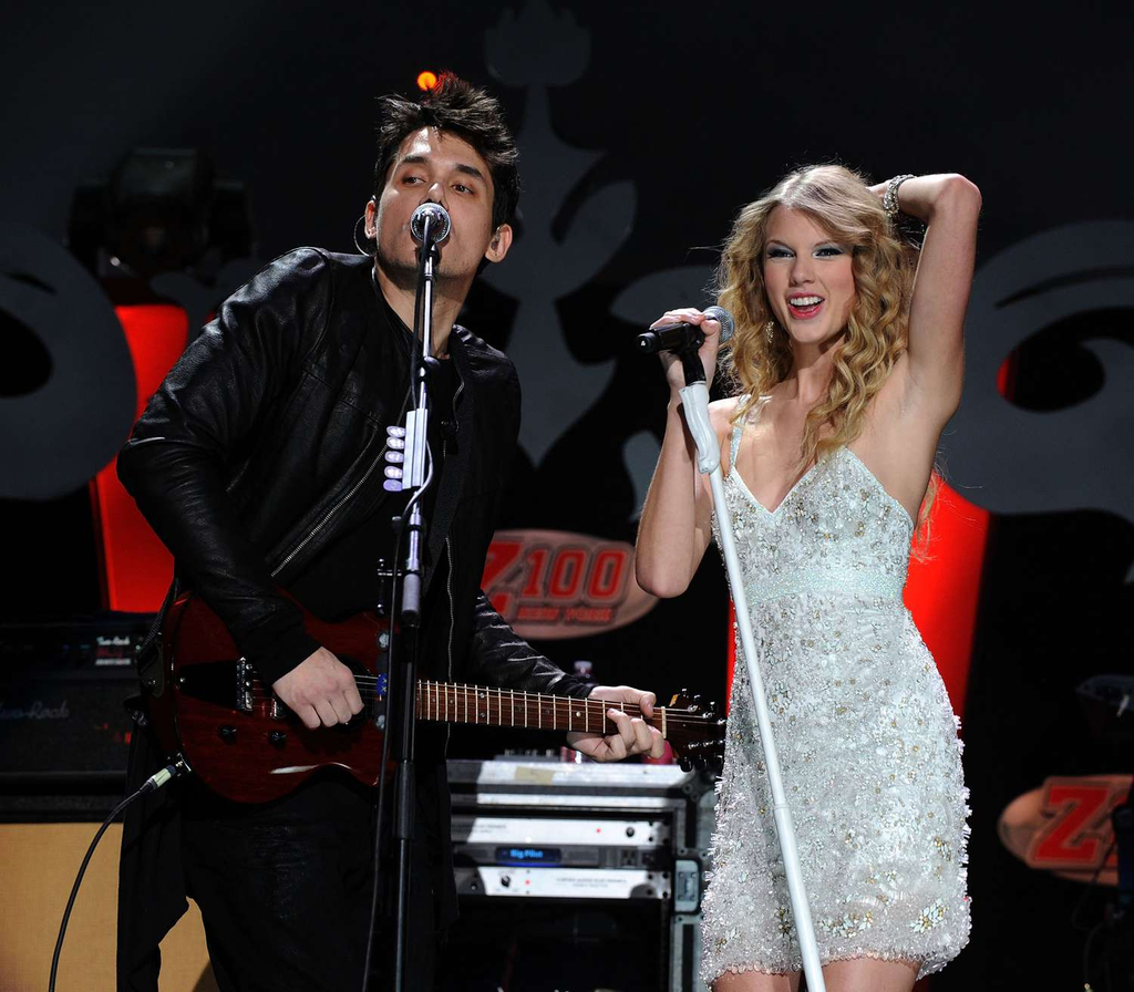 Taylor Swift and John Mayer performing together on stage at Z100's Jingle Ball in December 2009
