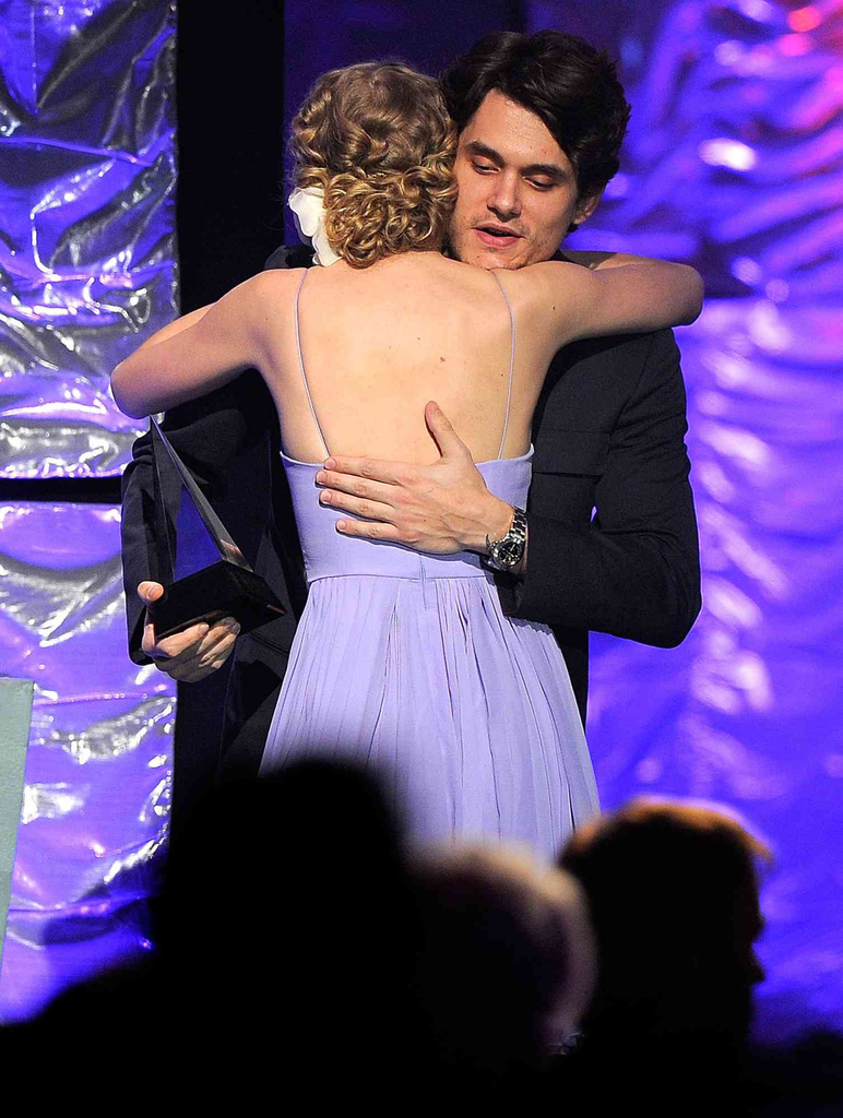 Taylor Swift and John Mayer hugging on stage